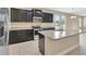 Well-equipped kitchen features stainless steel appliances, dark cabinetry, and granite countertops with a functional island at 15531 Waterleigh Cove Dr, Winter Garden, FL 34787