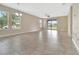 Spacious living area boasts tile flooring, large windows, and seamless flow to the outdoors through a sliding door at 15531 Waterleigh Cove Dr, Winter Garden, FL 34787