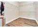 Spacious walk-in closet with wooden floors and ample wire shelving for optimal organization and storage at 15531 Waterleigh Cove Dr, Winter Garden, FL 34787