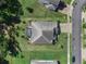 Aerial view of home showcasing the roof, driveway, manicured lawn, and screened-in pool area at 1640 Marsh Pointe Dr, Clermont, FL 34711