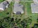 Aerial view of home, showing roof, driveway, and fenced-in backyard with screened-in patio at 1640 Marsh Pointe Dr, Clermont, FL 34711