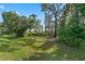 Expansive backyard featuring lush landscaping, mature trees, and a serene atmosphere at 1640 Marsh Pointe Dr, Clermont, FL 34711