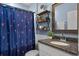 Charming bathroom with flamingo shower curtain and floating wooden shelves at 1640 Marsh Pointe Dr, Clermont, FL 34711