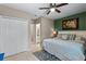 Cozy bedroom with closet, en suite bathroom, ceiling fan, and neutral toned furnishings at 1640 Marsh Pointe Dr, Clermont, FL 34711