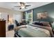 Bedroom featuring teal accent wall, large window, and ceiling fan at 1640 Marsh Pointe Dr, Clermont, FL 34711