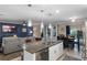 Open kitchen with granite island, stainless appliances and seamless connection to dining and living areas at 1640 Marsh Pointe Dr, Clermont, FL 34711