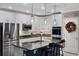 Modern kitchen with stainless steel appliances, granite countertops, and a stylish island with bar seating at 1640 Marsh Pointe Dr, Clermont, FL 34711