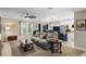 Bright living room with a cozy seating area, large windows, and open access to the modern kitchen and dining space at 1640 Marsh Pointe Dr, Clermont, FL 34711