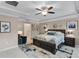 Comfortable main bedroom features neutral walls, tray ceiling, ceiling fan, and a decorative rug at 1640 Marsh Pointe Dr, Clermont, FL 34711