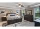 Comfortable main bedroom features neutral walls, tray ceiling, ceiling fan, and an area rug at 1640 Marsh Pointe Dr, Clermont, FL 34711