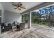 Screened patio with paved flooring, ceiling fan, and outdoor seating at 1640 Marsh Pointe Dr, Clermont, FL 34711