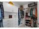 Walk-in closet with custom shelving, hanging rods, shoe racks, and ample storage space at 1640 Marsh Pointe Dr, Clermont, FL 34711