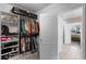 Walk-in closet with custom shelving, hanging rods, shoe racks, and access to bathroom at 1640 Marsh Pointe Dr, Clermont, FL 34711
