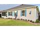 Exterior of home featuring a well-manicured lawn and blue shuttered windows at 1676 Van Buren Way, The Villages, FL 32162