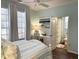 Bedroom featuring an ensuite bathroom, desk, and bright natural light at 1676 Van Buren Way, The Villages, FL 32162