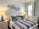 Comfortable bedroom with coastal decor, ample natural light, and hardwood floors at 1676 Van Buren Way, The Villages, FL 32162