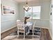 Cozy dining room features a charming table setting and nautical accents at 1676 Van Buren Way, The Villages, FL 32162