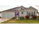 Beautiful home featuring a well-manicured lawn and garden decor at 1676 Van Buren Way, The Villages, FL 32162