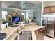 Granite kitchen counter overlooking the living area with stainless steel appliances at 1676 Van Buren Way, The Villages, FL 32162