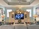 Bright living room showcasing a large entertainment center, comfortable seating, and decorative accents at 1676 Van Buren Way, The Villages, FL 32162