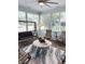Bright sunroom with ceiling fan, tile table, and comfortable seating at 1676 Van Buren Way, The Villages, FL 32162