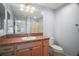 Bathroom with a single sink, vanity, mirror, and walk-in shower at 16827 Se 92Nd Lance Ct, The Villages, FL 32162