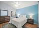 Relaxing bedroom with light blue walls, hardwood floors, and soft lighting at 16827 Se 92Nd Lance Ct, The Villages, FL 32162