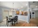 Cozy dining area features a round table, chandelier, and sliding glass doors to the patio at 16827 Se 92Nd Lance Ct, The Villages, FL 32162
