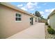 Home's back patio with beige concrete features sliding glass doors and windows at 16827 Se 92Nd Lance Ct, The Villages, FL 32162