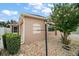 Beige home's side exterior with neutral rock landscaping and small flowering tree at 16827 Se 92Nd Lance Ct, The Villages, FL 32162