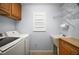 Functional laundry room with washer, dryer, sink, and storage for efficient chores at 16827 Se 92Nd Lance Ct, The Villages, FL 32162