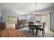 Open-concept living space with a dining area, living room, and sliding doors to the patio at 16827 Se 92Nd Lance Ct, The Villages, FL 32162