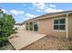 A spacious patio with sliding glass doors offers outdoor living space and backyard views at 16827 Se 92Nd Lance Ct, The Villages, FL 32162