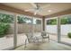 Enclosed patio with tile flooring, ceiling fan, and views of the gated backyard at 16827 Se 92Nd Lance Ct, The Villages, FL 32162