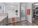 Bathroom featuring double sinks, soaking tub, walk-in shower, and walk-in closet at 1706 Augustine Dr, The Villages, FL 32159
