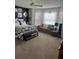 Inviting bedroom with cozy sitting area, large windows with coverings, and comfortable bedding at 1706 Augustine Dr, The Villages, FL 32159