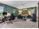 Green bedroom featuring a ceiling fan, home gym, work space, and neutral carpeting at 1706 Augustine Dr, The Villages, FL 32159