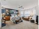 Bedroom with sitting area, ceiling fan, and multiple windows with natural light at 1706 Augustine Dr, The Villages, FL 32159