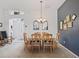 The dining room features a table with seating for six and a chandelier at 1706 Augustine Dr, The Villages, FL 32159