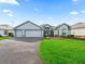 Charming single-story home with a well-maintained lawn and a two car garage at 1706 Augustine Dr, The Villages, FL 32159