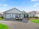 Charming home featuring a well maintained lawn and an attached two car garage at 1706 Augustine Dr, The Villages, FL 32159
