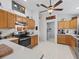 Kitchen featuring light wooden cabinets, white counters and a ceiling fan at 1706 Augustine Dr, The Villages, FL 32159
