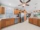 The kitchen features wooden cabinets, stainless steel appliances, and lots of counter space at 1706 Augustine Dr, The Villages, FL 32159