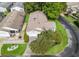 Aerial view of home with lush landscaping, stone paver driveway, and manicured lawn at 17324 Se 82Nd Pecan Ter, The Villages, FL 32162