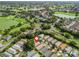 Beautiful aerial shot of a home surrounded by lush greenery, golf courses, and a scenic lake at 17324 Se 82Nd Pecan Ter, The Villages, FL 32162