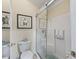 Bathroom featuring decorative turtle art and a glass-doored shower with white tile at 17324 Se 82Nd Pecan Ter, The Villages, FL 32162