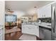 Bright, open concept kitchen with granite counters, stainless appliances, and view to living area at 17324 Se 82Nd Pecan Ter, The Villages, FL 32162