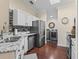 Updated kitchen with stainless steel appliances, granite counters, and adjacent laundry area at 17324 Se 82Nd Pecan Ter, The Villages, FL 32162