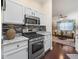 Modern kitchen with stainless steel appliances, granite counters and easy access to living space at 17324 Se 82Nd Pecan Ter, The Villages, FL 32162