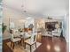 Open-concept living area with hardwood floors, dining area, and views into the kitchen at 17324 Se 82Nd Pecan Ter, The Villages, FL 32162